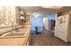 Bright kitchen featuring a double sink, wood-look floors, and an open view of the dining area at 9430 Sw 102Nd Pl, Ocala, FL 34481
