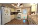 Efficient kitchen with white appliances, wood-look flooring, and eat in area at 9430 Sw 102Nd Pl, Ocala, FL 34481