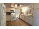 Functional kitchen with white appliances, wood-look flooring, and ample counter space at 9430 Sw 102Nd Pl, Ocala, FL 34481