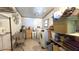 Laundry room includes washer, dryer, storage shelves, utility sink and a window at 9430 Sw 102Nd Pl, Ocala, FL 34481