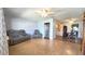 Spacious living room with a gray leather sofa set, wood floors, ceiling fan and open access to dining area at 9430 Sw 102Nd Pl, Ocala, FL 34481