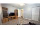 Comfortable living room features modern grey walls, wood-look floors, and custom entertainment center at 9430 Sw 102Nd Pl, Ocala, FL 34481