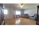 Comfortable living room with hardwood floors, cozy furniture, and natural light from the large window at 9430 Sw 102Nd Pl, Ocala, FL 34481