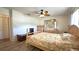 Bright main bedroom with wood-look flooring, wooden furniture, and a ceiling fan at 9430 Sw 102Nd Pl, Ocala, FL 34481