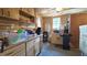 Mud room has a countertop with wooden cabinets, two windows, and is cluttered with items at 9430 Sw 102Nd Pl, Ocala, FL 34481