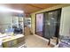 Functional office space featuring dual windows, wood ceiling, white shelving, and sliding glass doors at 9430 Sw 102Nd Pl, Ocala, FL 34481