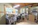 Office space features dual windows, wood ceiling, and white shelving for optimal storage at 9430 Sw 102Nd Pl, Ocala, FL 34481