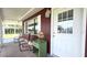 Inviting screened porch with comfortable seating and decorative plants, leading to the front door at 9430 Sw 102Nd Pl, Ocala, FL 34481