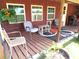 Covered porch with chairs, small table, and potted plants creates a welcoming outdoor space at 9430 Sw 102Nd Pl, Ocala, FL 34481