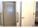 Modern bathroom featuring tiled standing shower with glass doors and chrome hardware at 9430 Sw 102Nd Pl, Ocala, FL 34481