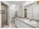 Well-lit bathroom featuring a walk-in shower, vanity with a sink, and ample storage space at 9667 Sw 94Th Ct # C, Ocala, FL 34481