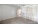 Bedroom with a ceiling fan, neutral carpet, and large closet doors at 9667 Sw 94Th Ct # C, Ocala, FL 34481