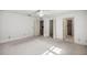 Spacious bedroom with neutral carpet, ceiling fan, and access to bathroom and walk-in closet at 9667 Sw 94Th Ct # C, Ocala, FL 34481