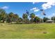 Well-manicured community lawn area featuring flagpoles, lush green grass, and meticulously maintained landscaping at 9667 Sw 94Th Ct # C, Ocala, FL 34481