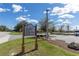 Community sign listing the amenities, set against a backdrop of lush landscaping and blue skies at 9667 Sw 94Th Ct # C, Ocala, FL 34481