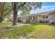 Charming single story home with green grass, decorative rocks, and mature shade trees at 9667 Sw 94Th Ct # C, Ocala, FL 34481