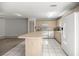 Kitchen area with a tile floor, white appliances, and light wood cabinetry and an island at 9667 Sw 94Th Ct # C, Ocala, FL 34481