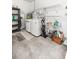 A well-lit laundry area with a washer, dryer, shelving, and ample storage space at 9667 Sw 94Th Ct # C, Ocala, FL 34481