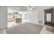 View of the living area showing the tile and carpet floor, open floorpan, and kitchen at 9667 Sw 94Th Ct # C, Ocala, FL 34481