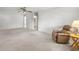 Spacious living room with neutral carpet, ceiling fan, and views into other rooms at 9667 Sw 94Th Ct # C, Ocala, FL 34481