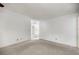 A view of the open living room area with carpet and a view of the kitchen at 9667 Sw 94Th Ct # C, Ocala, FL 34481