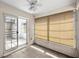 The screened porch overlooks the backyard and features tile flooring and a ceiling fan at 9667 Sw 94Th Ct # C, Ocala, FL 34481