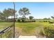 View of the lush backyard from the screened patio, with a well-maintained lawn and landscaping at 9839 Sw 90Th St, Ocala, FL 34481