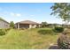Beautiful backyard featuring lush greenery, screened-in porch, and private landscaping at 9839 Sw 90Th St, Ocala, FL 34481