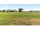 This large, green backyard features a wide open view of the manicured golf course at 9839 Sw 90Th St, Ocala, FL 34481
