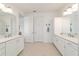 Bright bathroom with dual sinks and vanities, and white cabinets at 9839 Sw 90Th St, Ocala, FL 34481