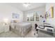 Bright bedroom featuring a cozy bed, a ceiling fan, and a functional workspace at 9839 Sw 90Th St, Ocala, FL 34481