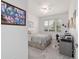 Bright bedroom featuring a cozy bed, a ceiling fan, and a functional workspace at 9839 Sw 90Th St, Ocala, FL 34481
