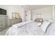 Bright bedroom with a large bed, ceiling fan, dresser, and comfortable seating at 9839 Sw 90Th St, Ocala, FL 34481