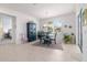 Dining room with decor and seating adjacent to hallway leading to bedroom at 9839 Sw 90Th St, Ocala, FL 34481