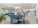 Dining table and chairs lead to kitchen and screened-in outdoor seating area at 9839 Sw 90Th St, Ocala, FL 34481