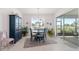 Bright dining room with sliding door access to the lanai and lush green view at 9839 Sw 90Th St, Ocala, FL 34481