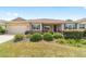 Inviting single Gathering home with manicured lawn, neutral paint and charming front porch at 9839 Sw 90Th St, Ocala, FL 34481