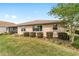 Rear exterior of the house with a screened patio and manicured lawn and landscaping at 9839 Sw 90Th St, Ocala, FL 34481