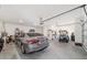 Spacious two car garage with extra storage, and a parked car and golf cart at 9839 Sw 90Th St, Ocala, FL 34481