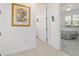 Hallway leading to bedroom featuring bright walls and elegant decor at 9839 Sw 90Th St, Ocala, FL 34481