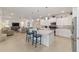 Open-concept kitchen with white cabinets, a center island, and adjacent living area at 9839 Sw 90Th St, Ocala, FL 34481
