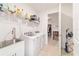 Functional laundry room with washer, dryer, sink, and shelving at 9839 Sw 90Th St, Ocala, FL 34481