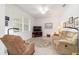 Comfortable living room featuring neutral decor, plush seating, and a large window at 9839 Sw 90Th St, Ocala, FL 34481