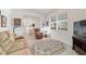 Inviting living room with recliner, sofa, area rug, and natural light at 9839 Sw 90Th St, Ocala, FL 34481