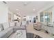 Bright living space features an open layout connecting to the kitchen and a comfortable armchair at 9839 Sw 90Th St, Ocala, FL 34481