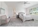 Light-filled bedroom featuring a sitting area, large window, and ensuite bathroom at 9839 Sw 90Th St, Ocala, FL 34481