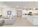 Spacious open floorplan integrating the living room and kitchen with white cabinetry and modern appliances at 9839 Sw 90Th St, Ocala, FL 34481