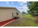A side view of the home's exterior, including the electrical panel and air conditioning condenser at 9940 Sw 101St Pl, Ocala, FL 34481