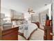 A cozy main bedroom with a large bed, wood furniture, and neutral-toned decor at 9940 Sw 101St Pl, Ocala, FL 34481