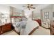 A cozy main bedroom with a large bed, wood furniture, and neutral-toned decor at 9940 Sw 101St Pl, Ocala, FL 34481